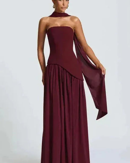 Burgundy strapless maxi dress with high slit and flowing draped fabric detail