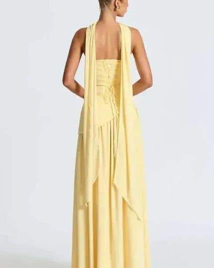Back view of yellow strapless maxi dress with open back and high leg slit
