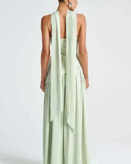 Back view of sage green strapless maxi dress with open back and high slit