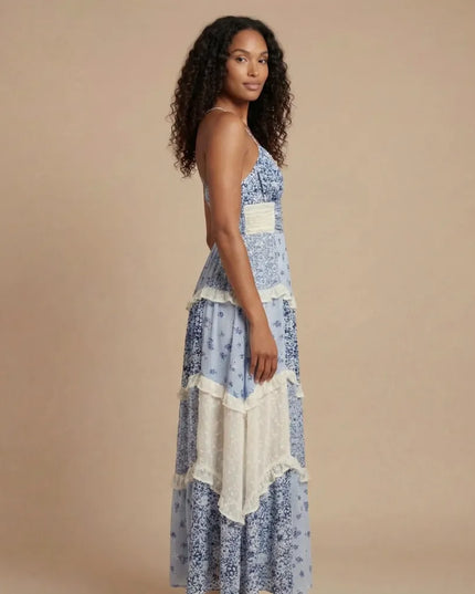 Blue floral V-neck maxi dress with tiered ruffles and cream trim, side view