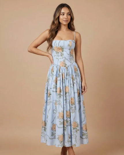 Side view of blue floral strapless midi dress with fitted waist and flowing skirt