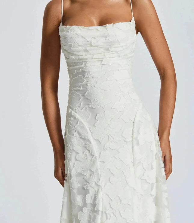 Close-up of white floral cowl neck maxi dress bodice with textured floral overlay