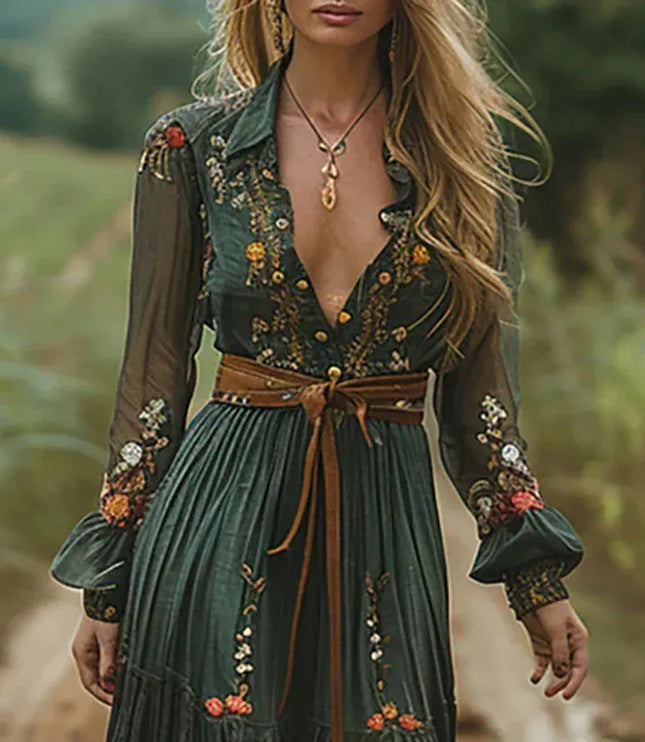 Close-up of a dark green floral V neck maxi dress with sheer sleeves and tied waist belt