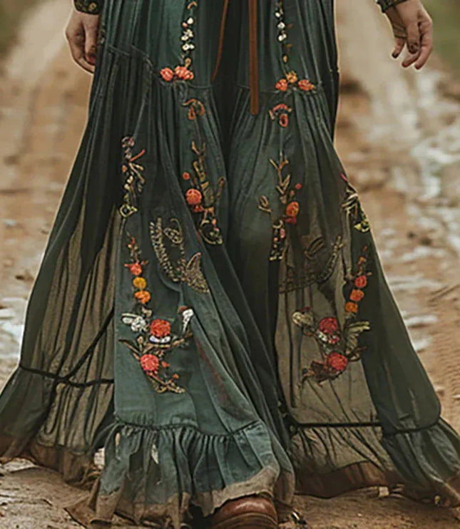 Lower half of a dark green floral maxi dress showing flowing skirt and ruffled hem detail