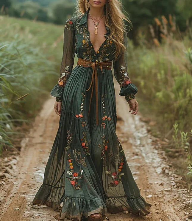 Dark green floral V neck maxi dress with sheer sleeves and brown belt on a model outdoors