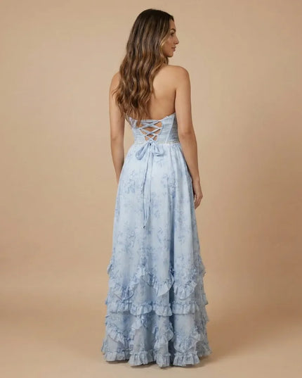 Back view of light blue floral halter maxi dress with lace-up back and ruffled hem