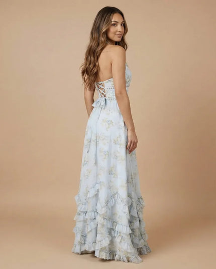 Side view of pale blue floral halter maxi dress showing open back and flowing skirt