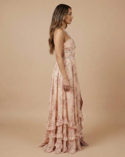 Side view of peach floral halter maxi dress with open back and tiered ruffle detail