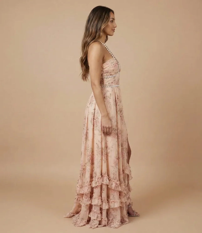Side view of peach floral halter maxi dress with open back and tiered ruffle detail