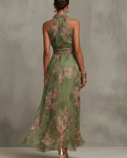 Back view of women floral halter maxi dress in green sheer fabric with pink blossoms
