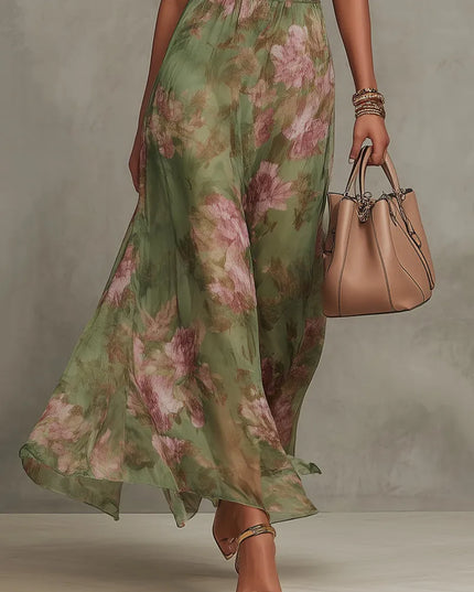 Lower front view of women floral maxi dress showing sheer floral skirt and gold heel sandals