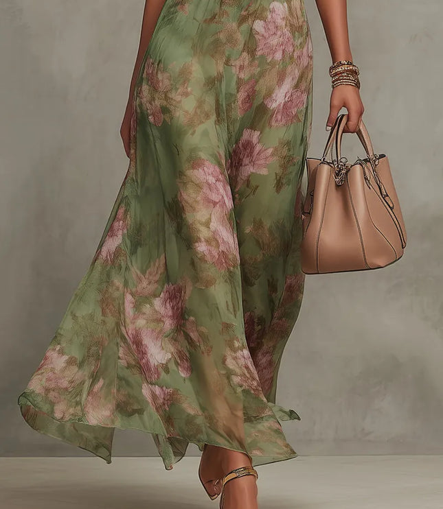 Lower front view of women floral maxi dress showing sheer floral skirt and gold heel sandals