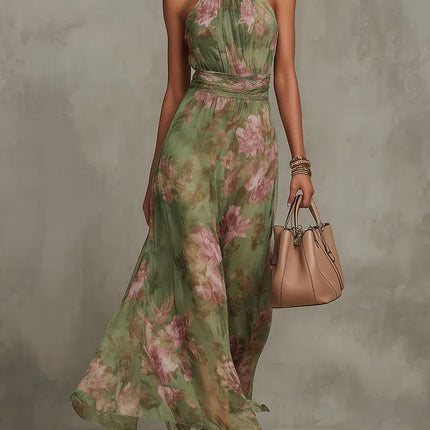 Women floral halter maxi dress in green with pink print, front view with flowing skirt and handbag