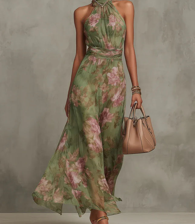Women floral halter maxi dress in green with pink print, front view with flowing skirt and handbag