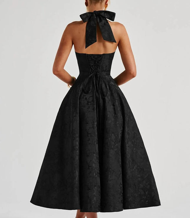 Back view of black floral halter midi dress with open back, bow neck tie, and corset lacing