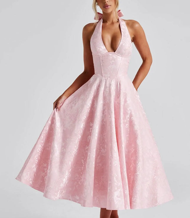 Pink floral halter midi wedding guest dress with full skirt and fitted bodice