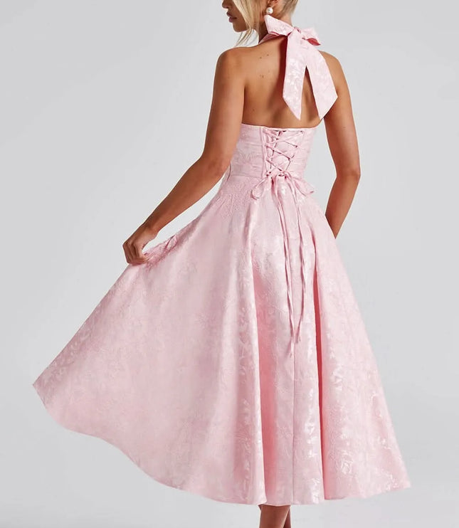 Back view of pink floral halter midi dress with lace-up back and tied neck sash