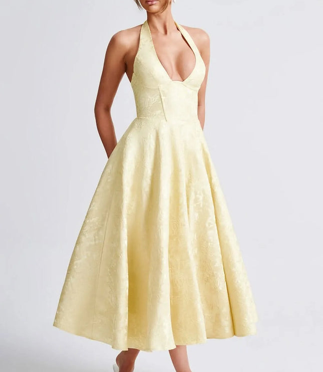 Pale yellow floral halter midi wedding guest dress with deep V neckline and full skirt
