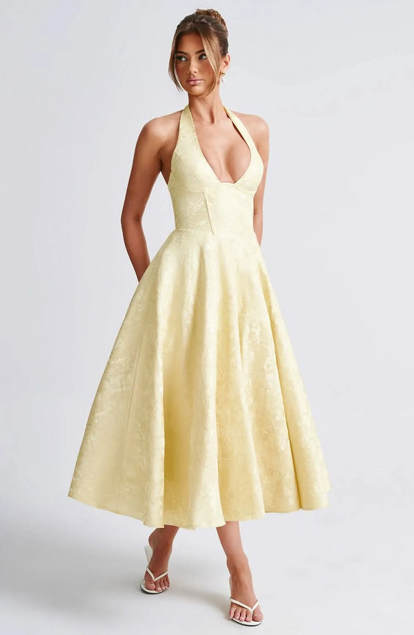 Pale yellow floral halter midi wedding guest dress with deep V neckline and full skirt