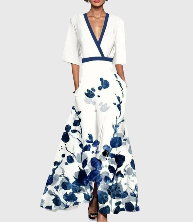 Women printed V neck maxi dress with white base, navy floral print, and long flared skirt
