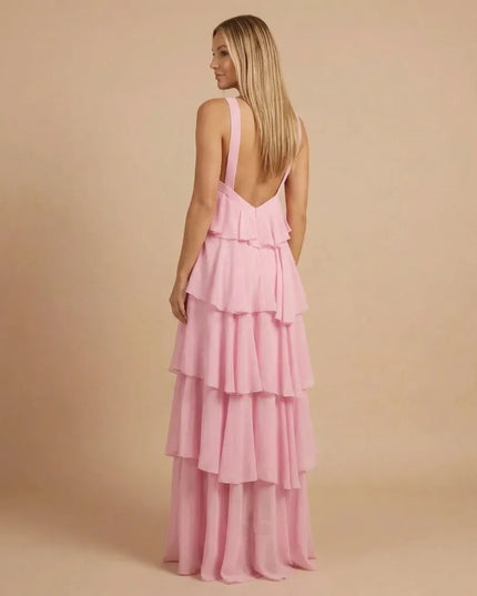 Back view of pink halter tiered maxi dress with open back and layered skirt