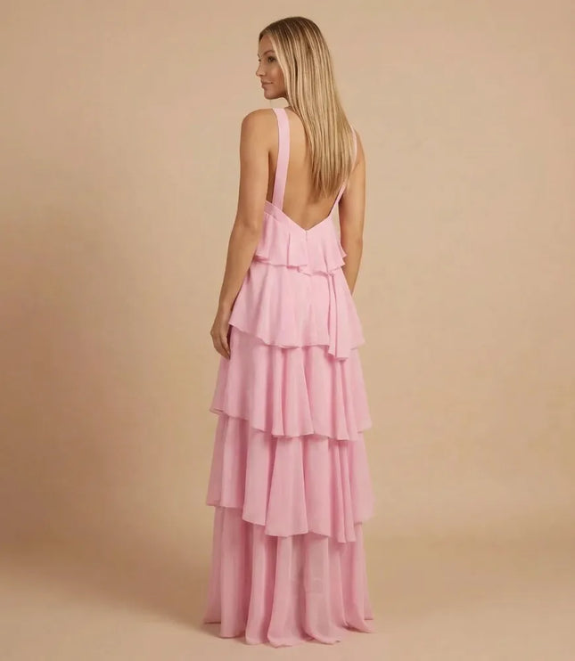 Back view of pink halter tiered maxi dress with open back and layered skirt