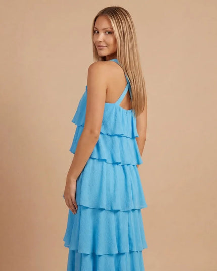Side back view of blue halter tiered maxi dress with open back and tiered layers