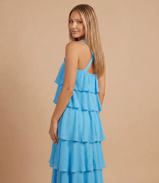 Side back view of blue halter tiered maxi dress with open back and tiered layers