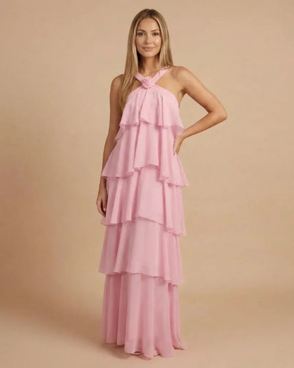 Pink halter tiered maxi dress with layered ruffles and floor-length flow
