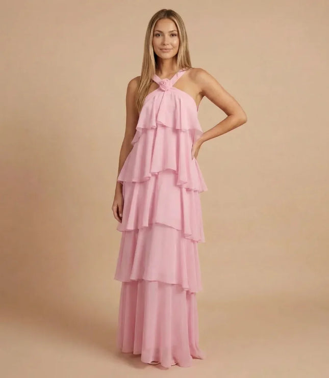 Pink halter tiered maxi dress with layered ruffles and floor-length flow